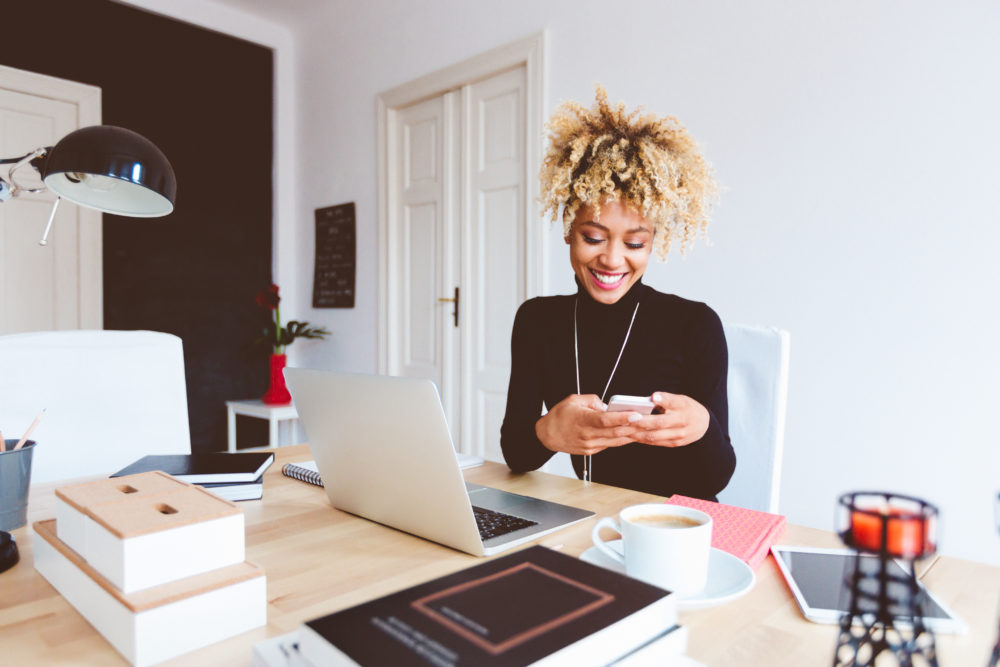 Afro american young woman in a home office - The PA Club